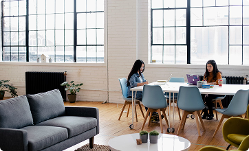 Modern office workspace with team using Carter platform for campaign management