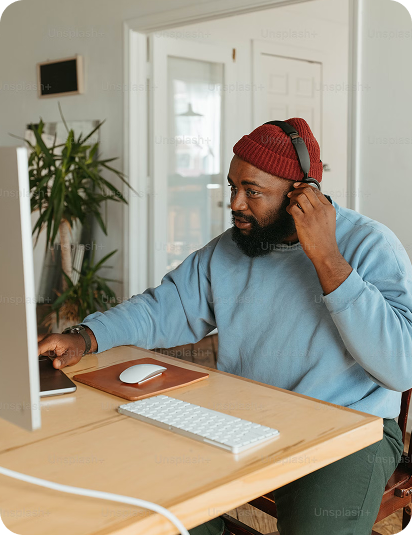 Remote worker with headphones managing digital campaigns from modern home office setup